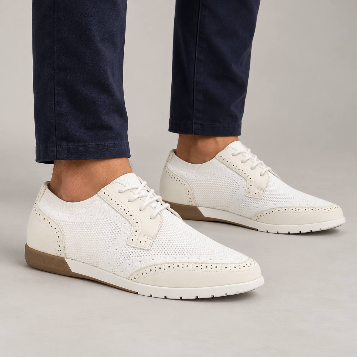White knit dress sneakers worn with navy chinos